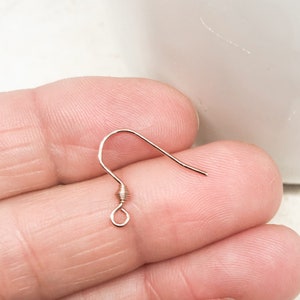 May include: A gold-toned earring hook with a wire wrapped loop at the top.