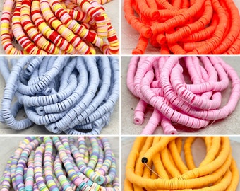 Könnte beinhalten: Sortiment an bunten Kunststoffperlen in verschiedenen Farben, darunter Rot, Orange, Pink, Blau, Gelb und Lila. Die Perlen sind in Stapeln angeordnet und bereit für Bastelprojekte.