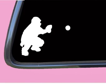 May include: White silhouette of a baseball catcher in a crouching position with a baseball flying towards them. The image is on a black background.