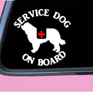 May include: White vinyl sticker with a silhouette of a dog wearing a red cross on its back. The text "SERVICE DOG ON BOARD" is in a circle around the dog.