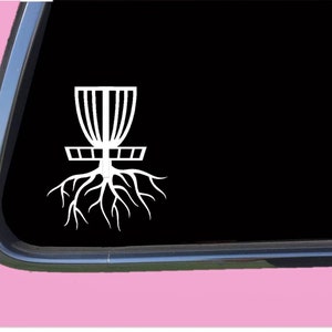 May include: White vinyl decal of a disc golf basket with roots growing from the base. The decal is on a black background.