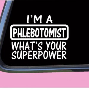 May include: A black and white car window sticker with the text "I'm a Phlebotomist. What's your superpower?"