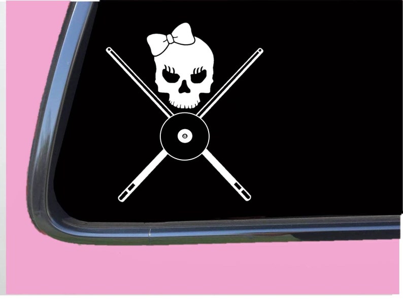 May include: White vinyl decal of a skull wearing a bow, with crossed pool cues and a pool ball in the center.