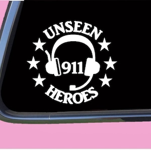 May include: White vinyl decal with the text "Unseen 911 Heroes" in a circle with five stars around it. A white headset with a microphone is inside the circle.