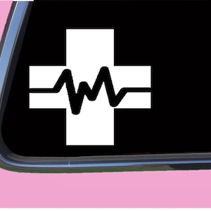 May include: White cross with a black EKG heart beat line graphic. The cross is a symbol of medical care and the EKG line represents a heartbeat.