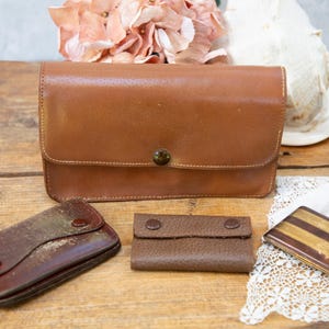Portaspazzole vintage in pelle. Portamonete. Ganci portachiavi. Porta biglietti da visita e carta per sigarette. 4 pezzi. Anni '50-'60 circa.