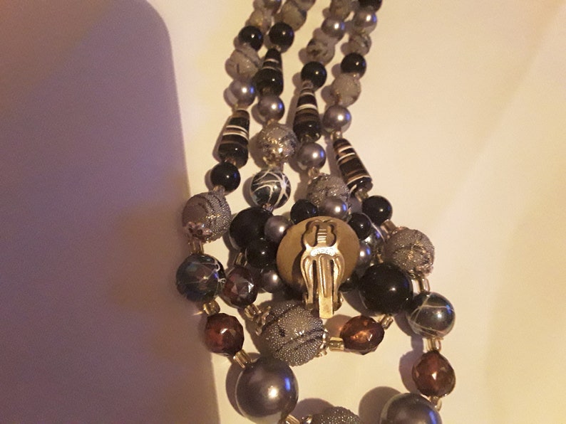 Two strand necklace and cluster clip earrings made in Japan Mark Japan on the back of the earrings and on the necklace clasp