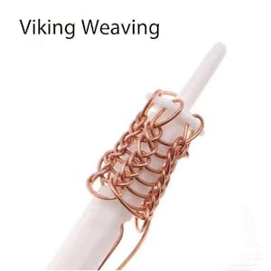 May include: A close-up of a white plastic tool with a copper chainmaille weave. The tool is used for creating chainmaille jewellery. The text "Viking Weaving" is visible at the top of the image.