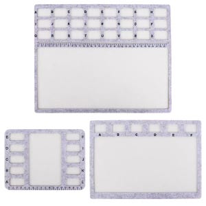 May include: Three grey felt mats with white centres. Each mat has a grid of lettered boxes and a ruler along one edge. The largest mat has letters A to X. The smaller mats have letters A to L and A to F.