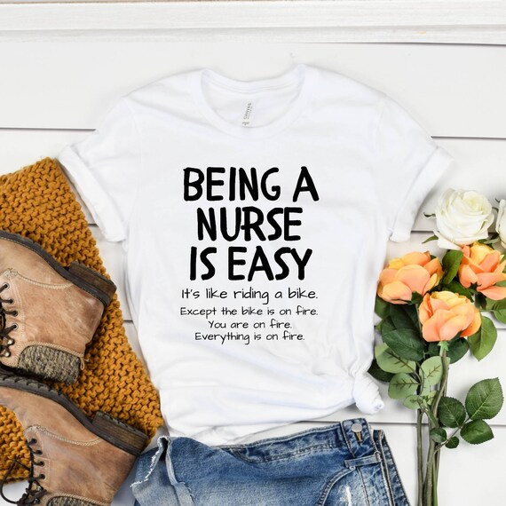 Being a nurse is easy it's like riding a bike except the bike is on fire you are on fire everything is on fire t-shirt, nurse premium shirt