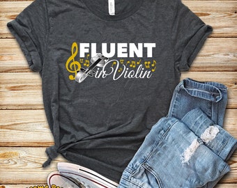 May include: A dark grey t-shirt with the text "Fluent in Violin" in white lettering. A musical note and a violin are depicted in gold.