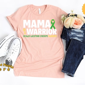 Mama eines Kriegers, Beckwith Wiedemann-Syndrom, Beckwith Awareness, gelb grünes Band, schwarzes Band, Beckwith-Band, Unisex-Tee