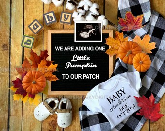 May include: A black letter board with the text "We are adding one little pumpkin to our patch".  The board is surrounded by fall-themed decorations, including a white onesie with the text "Baby Anderson Due Oct 2024", a pair of white baby booties, and a few pumpkins and fall leaves.