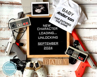 May include: A black chalkboard with the text "NEW CHARACTER LOADING... UNLOCKING SEPTEMBER 2024". A white onesie with the text "BABY Anderson HAS ENTERED THE GAME". A red and gray video game gun, a gray and black video game controller, and a white ultrasound image are also in the image.