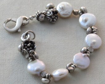 Lusterous pearl bracelet with Sterling flower beads and lobster clasp