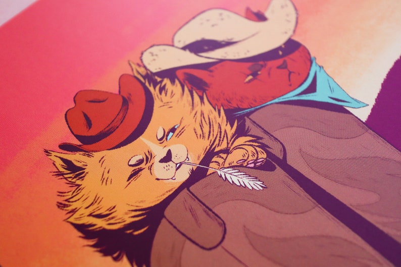 May include: Two cartoon cats wearing cowboy hats. The cat on the left is orange and has a feather in its mouth. The cat on the right is red and has a blue bandana around its neck.