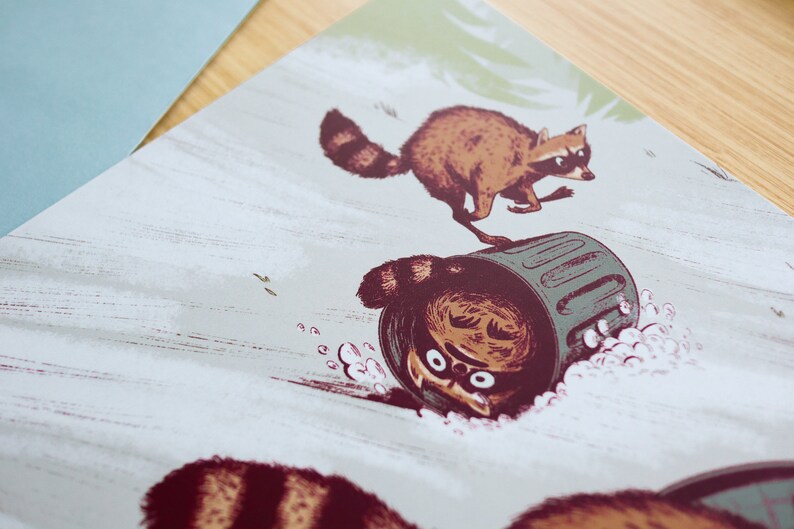 May include: A whimsical illustration of three raccoons, one of which is upside down in a green bin. The raccoons are drawn in a cartoon style with brown fur and black eyes. The background is a light grey with a subtle texture.