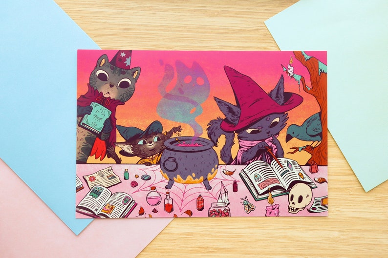 May include: Three black cats dressed as witches are gathered around a cauldron with a pink liquid inside. They are surrounded by books, crystals, and other magical supplies. The background is a sunset with a pink and orange sky.