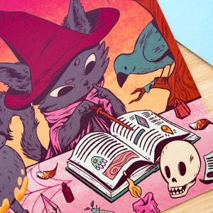 May include: A black cat wearing a pink and red witch's hat and robe is reading a book with a wand in its paw. A blue bird is perched on a branch in the background. There is a cauldron with a purple liquid, a skull, and other magical items on the table.