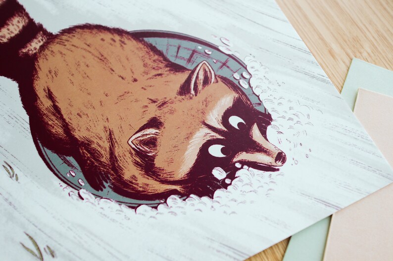 May include: A cartoon illustration of a raccoon peeking out of a sewer drain with a surprised expression. The raccoon is brown with a black tail and white fur around its eyes. The drain is grey and has a white rim. The background is white with a wood grain texture.