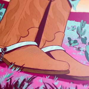 May include: A pair of brown leather cowboy boots with silver spurs and white accents. The boots are set against a pink and green desert landscape with cactus plants.