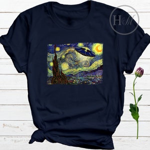 May include: A navy blue t-shirt with a print of Vincent van Gogh's Starry Night with a UFO flying over the town.