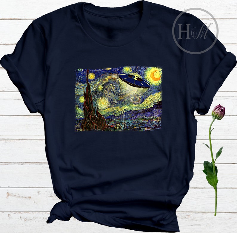 May include: A navy blue t-shirt with a print of Vincent van Gogh's Starry Night with a UFO flying over the town.