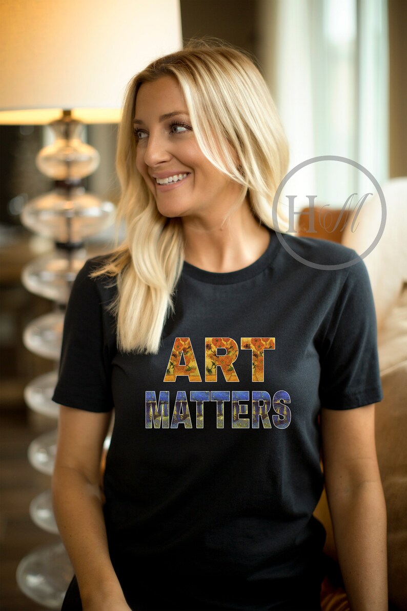 May include: A black t-shirt with the words "ART MATTERS" printed in large letters. The letters are made up of images of famous paintings.