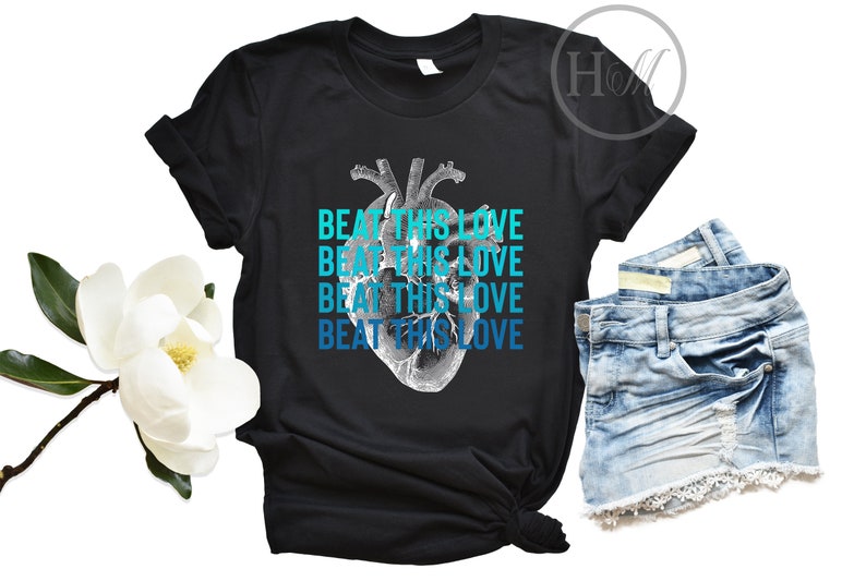 May include: Black t-shirt with a graphic of a heart and the text "Beat This Love" repeated four times in blue and teal.
