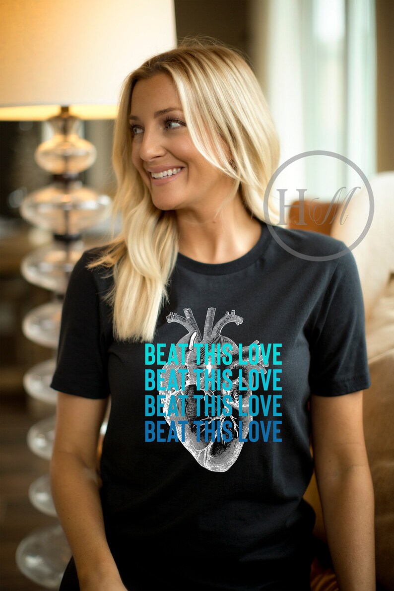 May include: A black t-shirt with a graphic of a human heart and the text "Beat This Love" repeated four times in a gradient of blue.