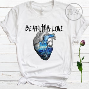 May include: White t-shirt with a black graphic of a heart with a starry night painting inside. The text "BEAT THIS LOVE" is above the heart.
