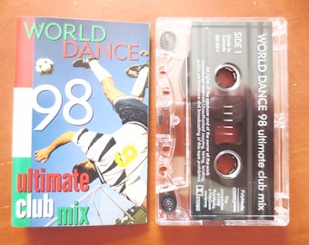 May include: A cassette tape with a black and white image of a soccer player on the front. The tape is labeled "WORLD DANCE 98 ultimate club mix".