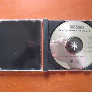 May include: A silver CD case with a black CD inside. The CD is labeled "Black Sabbath - Vol. 4" and lists the song titles on the back. The case is open and the CD is visible.