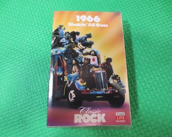 May include: A cassette tape case featuring a colourful image of a group of people on a bus. The case is labelled "1966 Shakin' All Over" and "Classic Rock" with the Time Life Music logo.