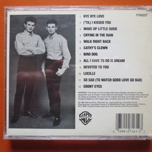 May include: A black and white photograph of two men in suits on the back of a compact disc case. The case is for the album "('Til) I Kissed You" by The Everly Brothers. The track listing is printed on the back of the case.