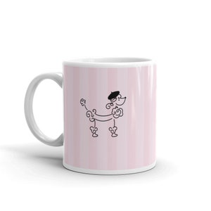 May include: White ceramic mug with a pink and white striped design. A black and white illustration of a poodle wearing a beret is centered on the mug.