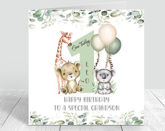 May include: A square birthday greeting card featuring a large light green number one, a giraffe, a lion cub, and a koala. The text reads One Today, LEO, and HAPPY BIRTHDAY TO A SPECIAL GRANDSON. The design includes balloons and eucalyptus leaves.