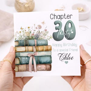May include: A square birthday greeting card featuring a stack of five vintage-style books topped with wildflowers and butterflies. The text reads Chapter 30, Thirty, Happy Birthday To a special Friend, Chloe, 1996, 30 & Fabulous, and WITH LOVE.