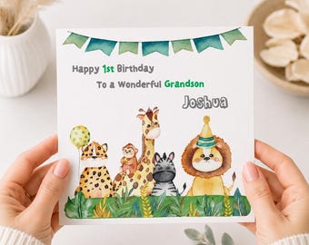 May include: A square greeting card featuring watercolor illustrations of a leopard with a yellow balloon, a monkey, a giraffe, a zebra, and a lion wearing a party hat. Text reads: Happy 1st Birthday To a Wonderful Grandson Joshua, with green bunting.