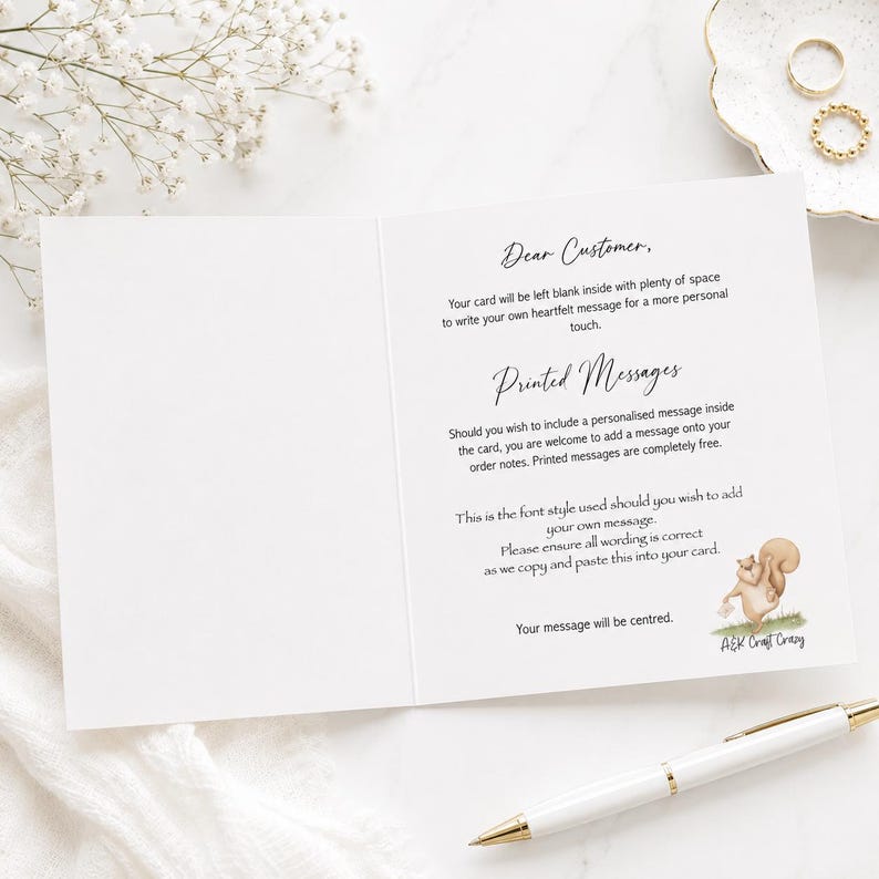 May include: A white greeting card with black text explaining personalisation options. The text reads: Dear Customer, Your card will be left blank inside with plenty of space to write your own heartfelt message for a more personal touch. Printed Messages, Should you wish to include a personalised message inside the card, you are welcome to add a message onto your order notes. Printed messages are completely free. This is the font style used should you wish to add your own message. Please ensure all wording is correct as we copy and paste this into your card. The message will be centred. A small illustration of a squirrel holding a letter is at the bottom right with the text A&K Craft Crazy.