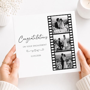 May include: A square white engagement card featuring the text Congratulations ON YOUR ENGAGEMENT and the date 12.05.2026. To the right, a vertical black film strip graphic contains three black and white photographs of a couple.
