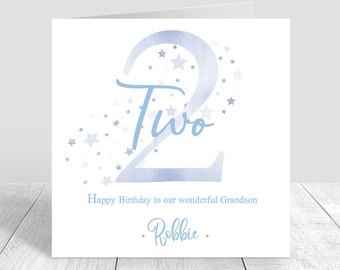 May include: A blue watercolor number two with white stars and the word "Two" written in cursive. The text "Happy Birthday to our wonderful Grandson - Robbie -" is below the number.
