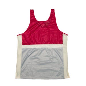 May include: A sleeveless vest top in a colour block design. The top features a red upper section, a white horizontal stripe, and a grey lower section. The sides have vertical white stripes.