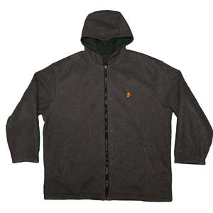 May include: A dark gray hooded jacket with a full-length zipper and a small orange emblem on the chest. The interior lining of the hood is a dark green color. The jacket has long sleeves and a relaxed fit.
