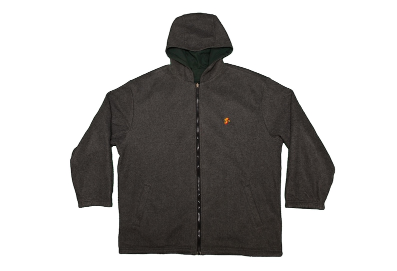 May include: A dark gray hooded jacket with a full-length zipper and a small orange emblem on the chest. The interior lining of the hood is a dark green color. The jacket has long sleeves and a relaxed fit.