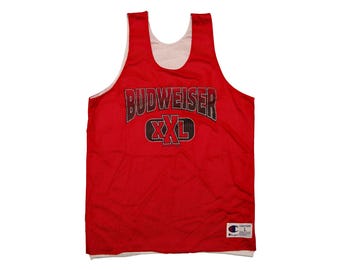 May include: Red mesh basketball jersey with white trim and the text "Budweiser XXL" in black and gray lettering. The jersey has a Champion logo on the bottom right.