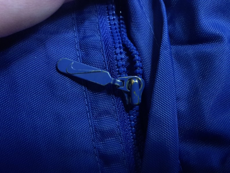 NIKE jacket with big Swoosh zipper closure two zipper side ...