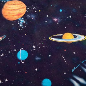 May include: A colorful space-themed illustration featuring planets, galaxies, and stars against a dark blue background. The artwork includes a large orange planet, a planet with rings, and several blue planets. The image is signed in the lower right corner.