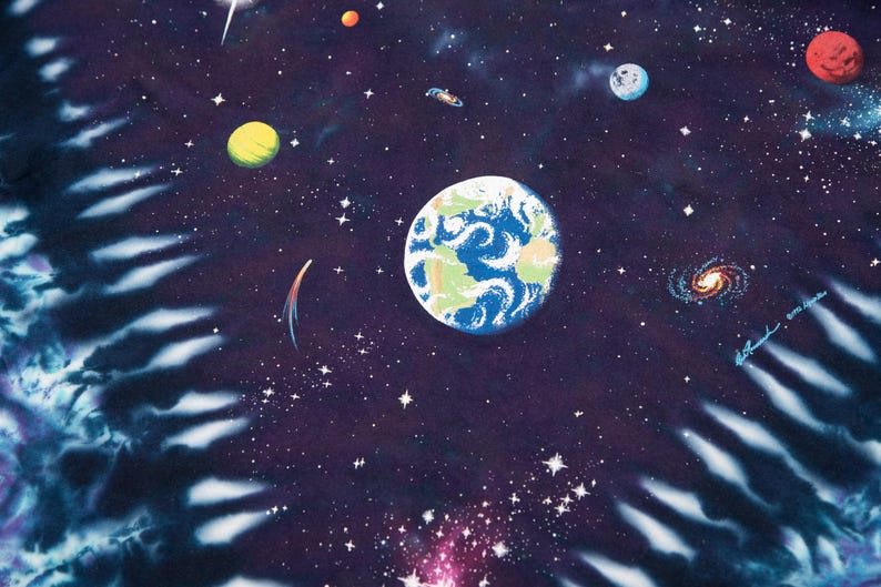 May include: A vibrant, tie-dye style illustration of outer space. The image features planets, stars, galaxies, and a comet against a dark blue and purple background. The Earth is depicted with blue oceans and green continents.