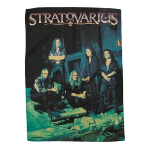 May include: A band poster featuring the band Stratovarius. The poster has a dark blue background with a band logo in the top center. Five band members are standing in front of a dark blue background. The band members are wearing dark clothing and are looking at the camera.